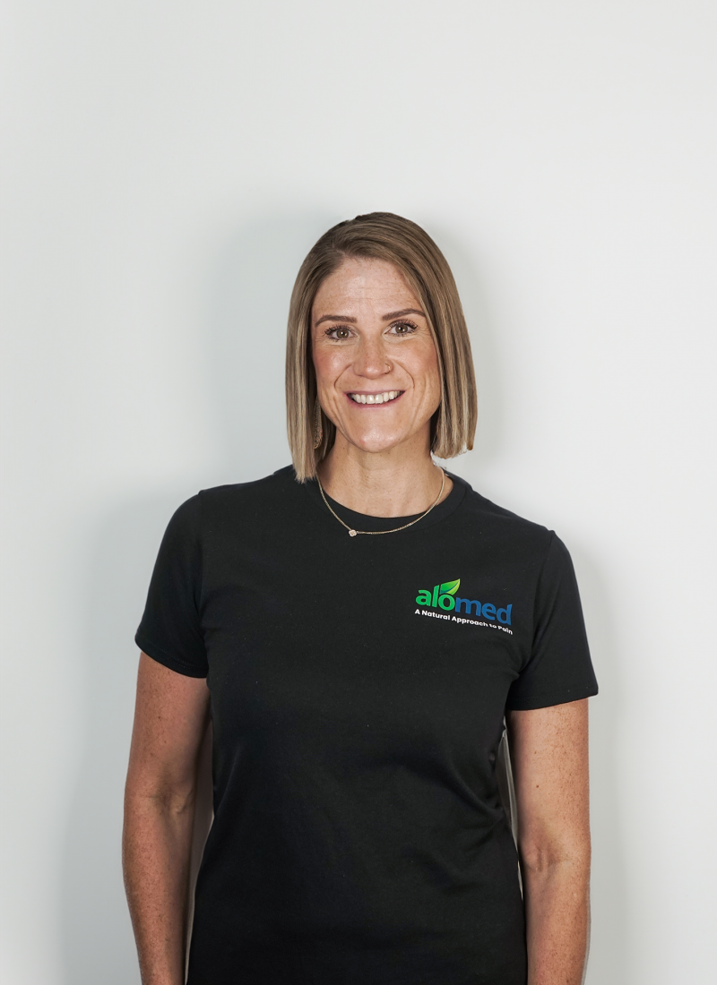 Amber O'Connor smiling and wearing a black Alomed-branded t-shirt.